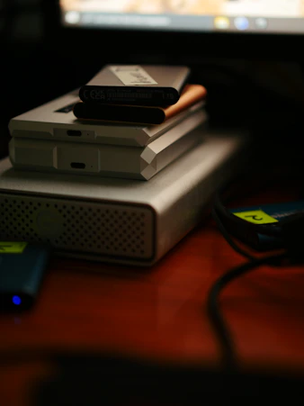 gray and black electronic device on brown wooden table