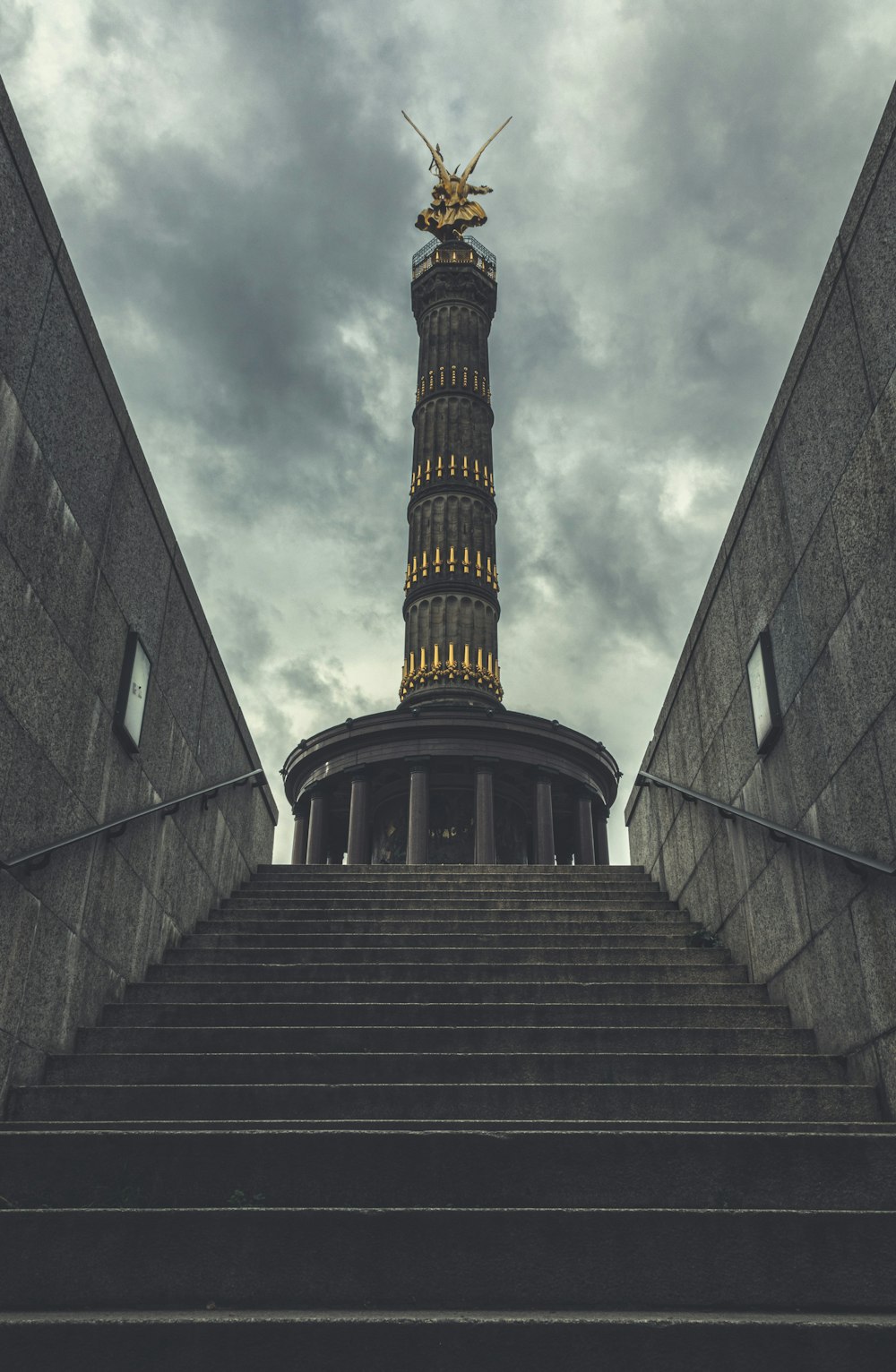 gray concrete building under cloudy sky during daytime