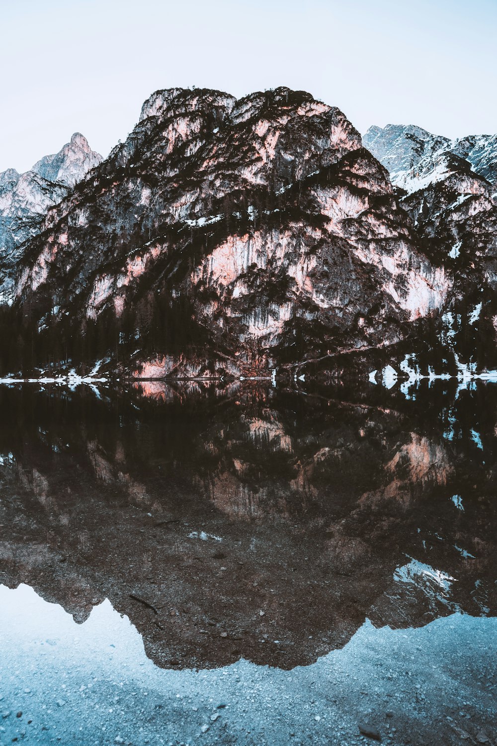 lake near snow covered mountain