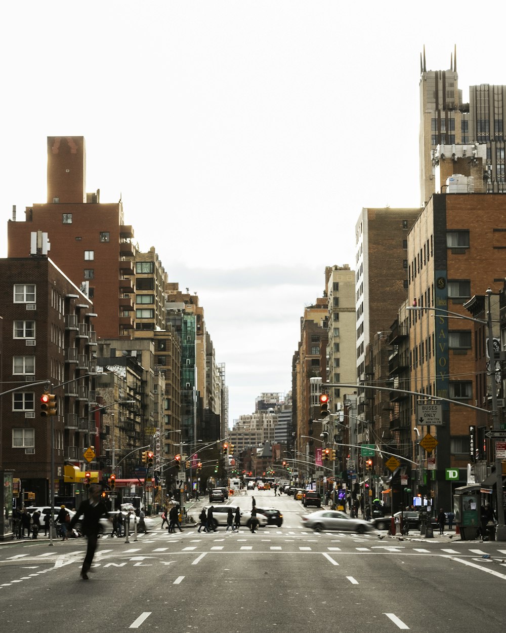 people walking on pedestrian lane near high rise buildings during daytime