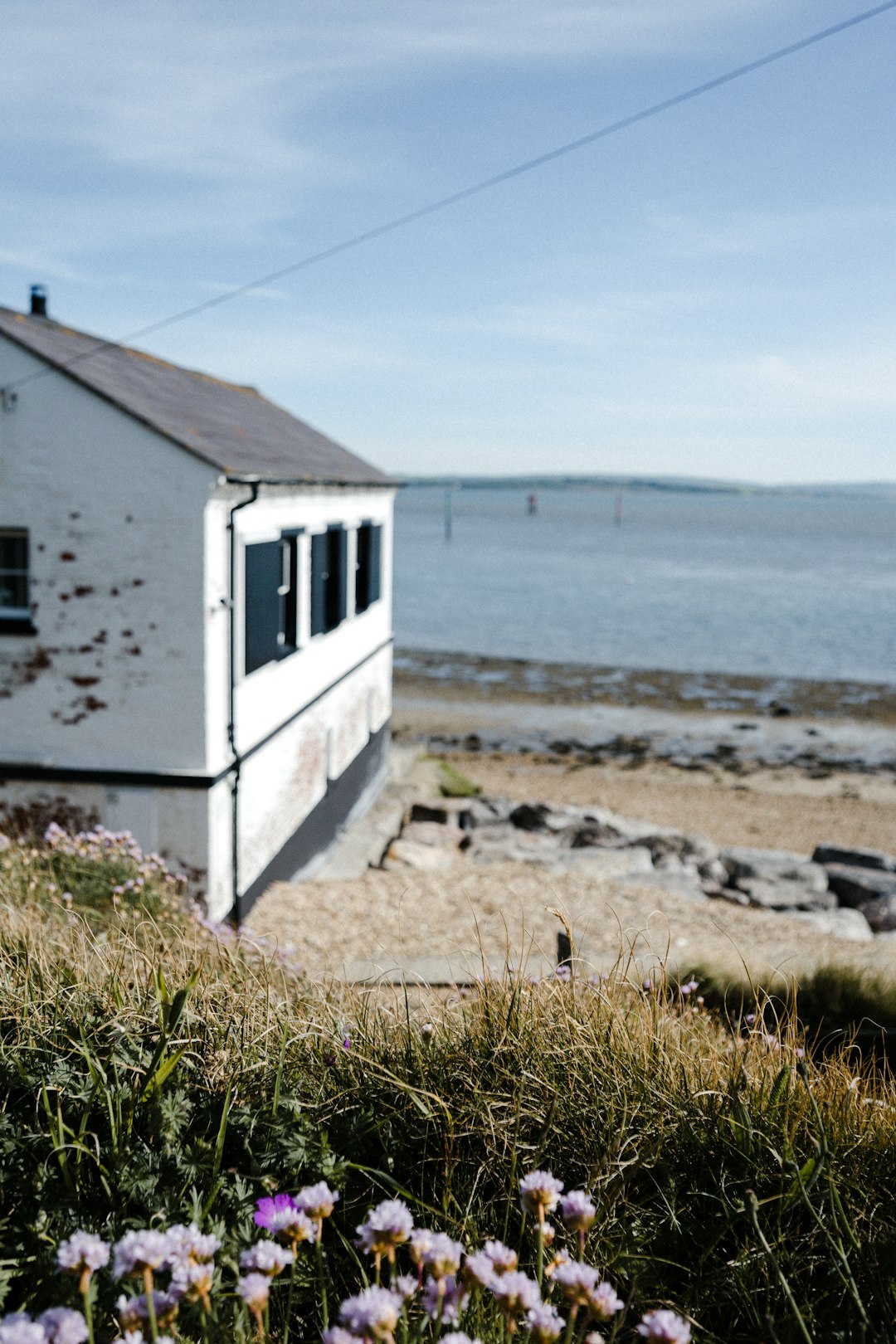 white wooden house on seashore during daytime