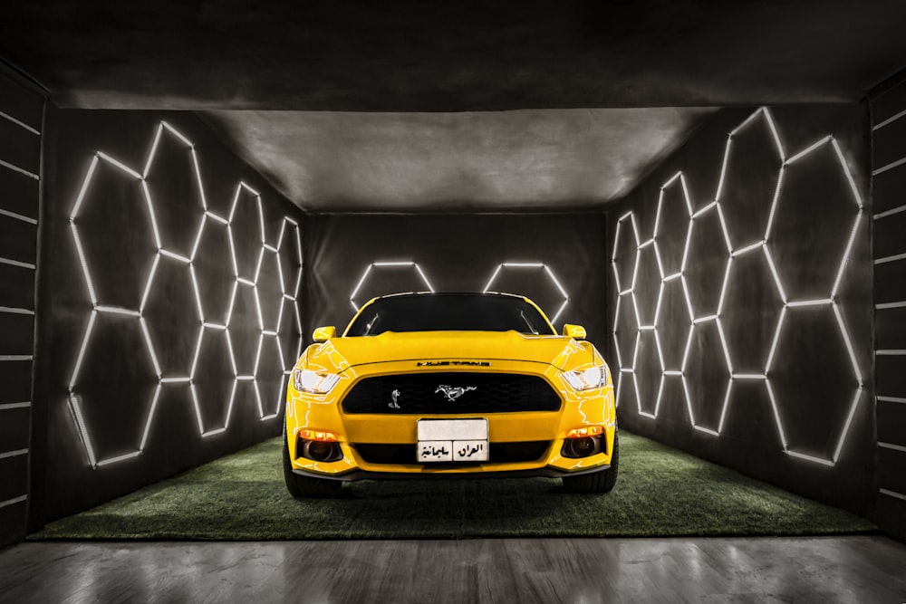 yellow chevrolet camaro in a black room