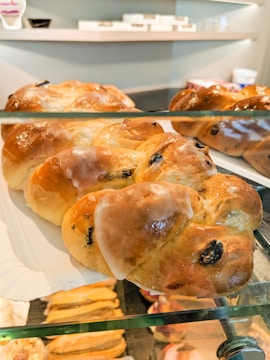 A sleek bakery display featuring pastries glazed with natural fruit jams.
