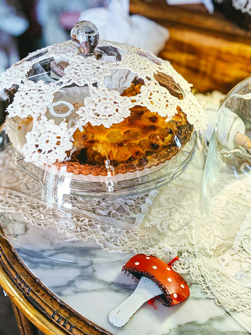 clear glass bowl with white and brown cake