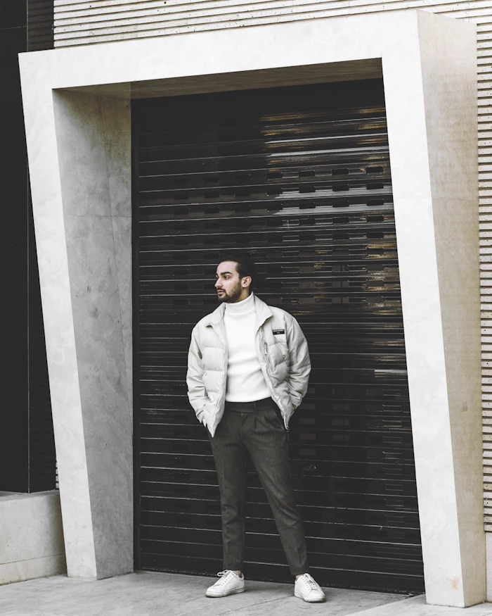 Man in a light jacket in a concrete doorway