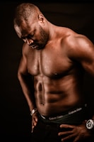 topless man wearing black bottoms