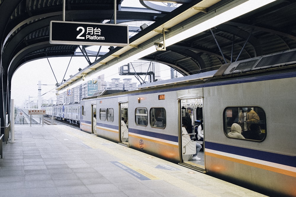 white and black train in train station