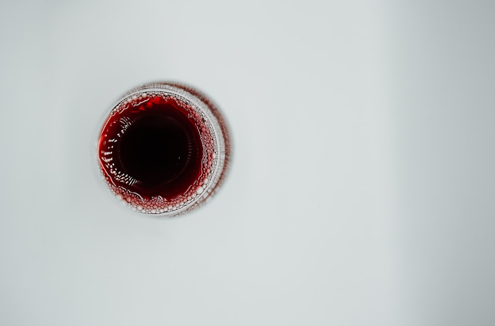 red round ornament on white surface