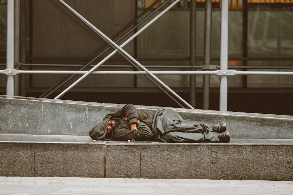 man lying on concrete stairs