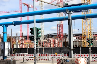 blue metal bridge with red and white flag during daytime