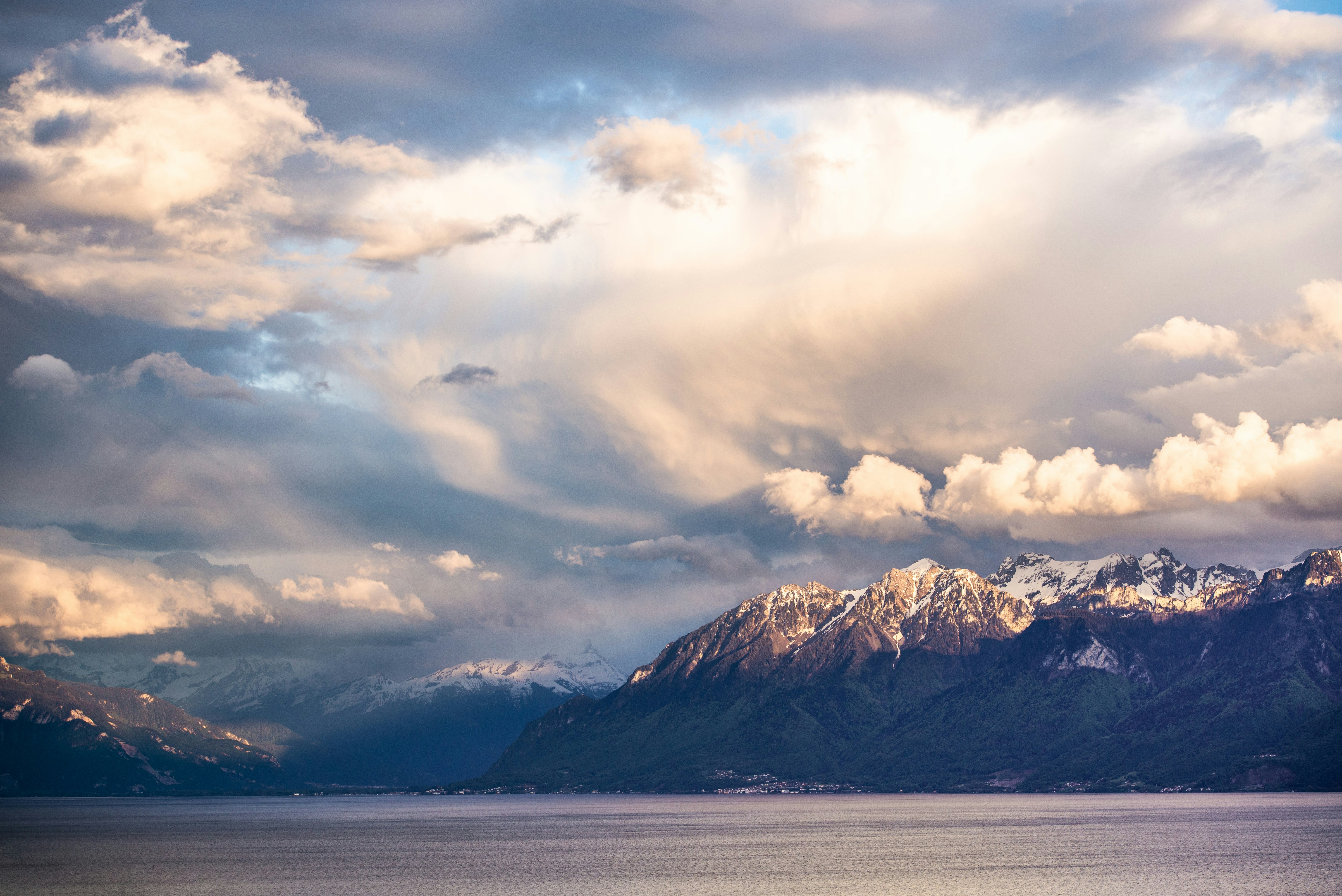 snow covered mountain under cloudy sky during daytime