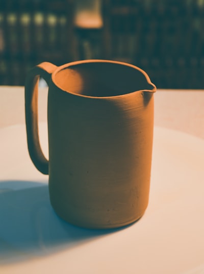 Hand-thrown terracotta carafe — Nasim Keshmiri on Unsplash