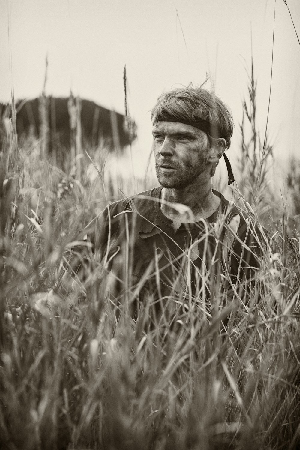 man in black and white plaid button up shirt standing on grass field