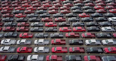 red and black cars on parking lot during daytime