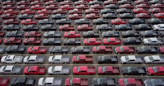 red and black cars on parking lot during daytime