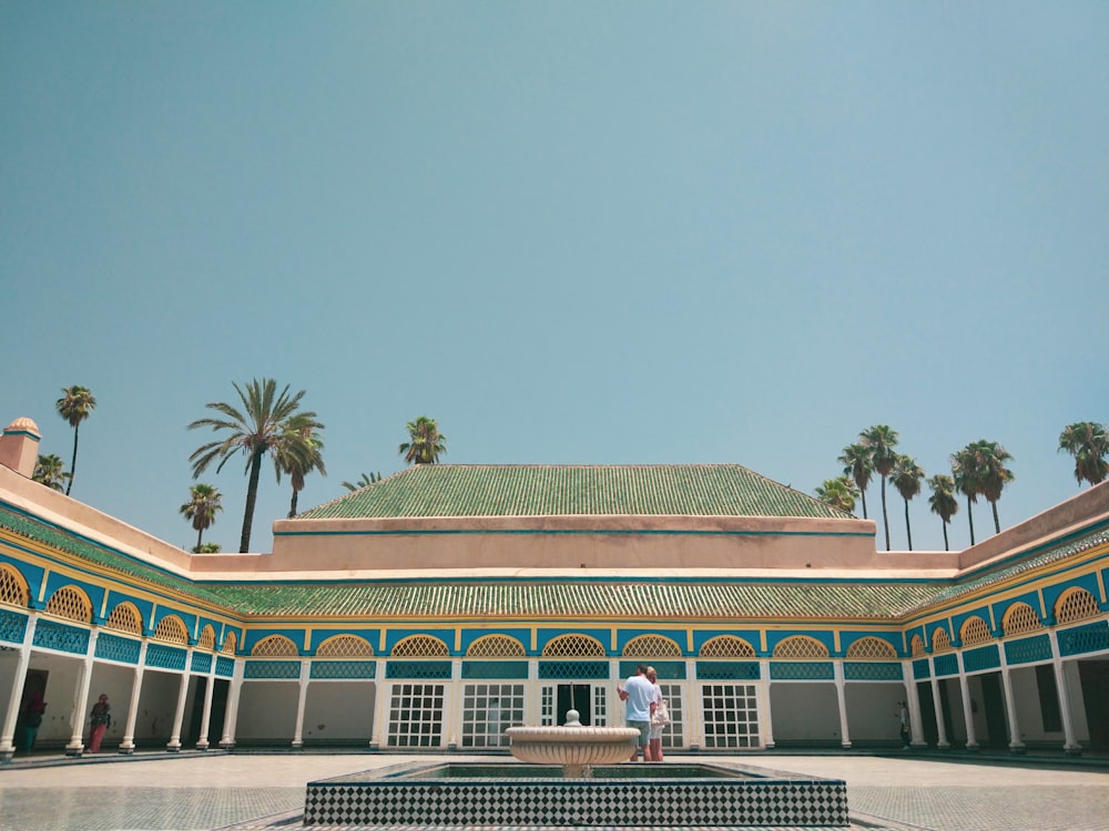 green palm tree near white and brown concrete building