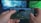 A person is holding a smartphone horizontally, playing a video game that involves a character parachuting into an open area. The screen shows various game interface elements including a compass, a mini-map, and player stats. The background has a blurred and colorful setting, suggesting a focus on the gaming experience.