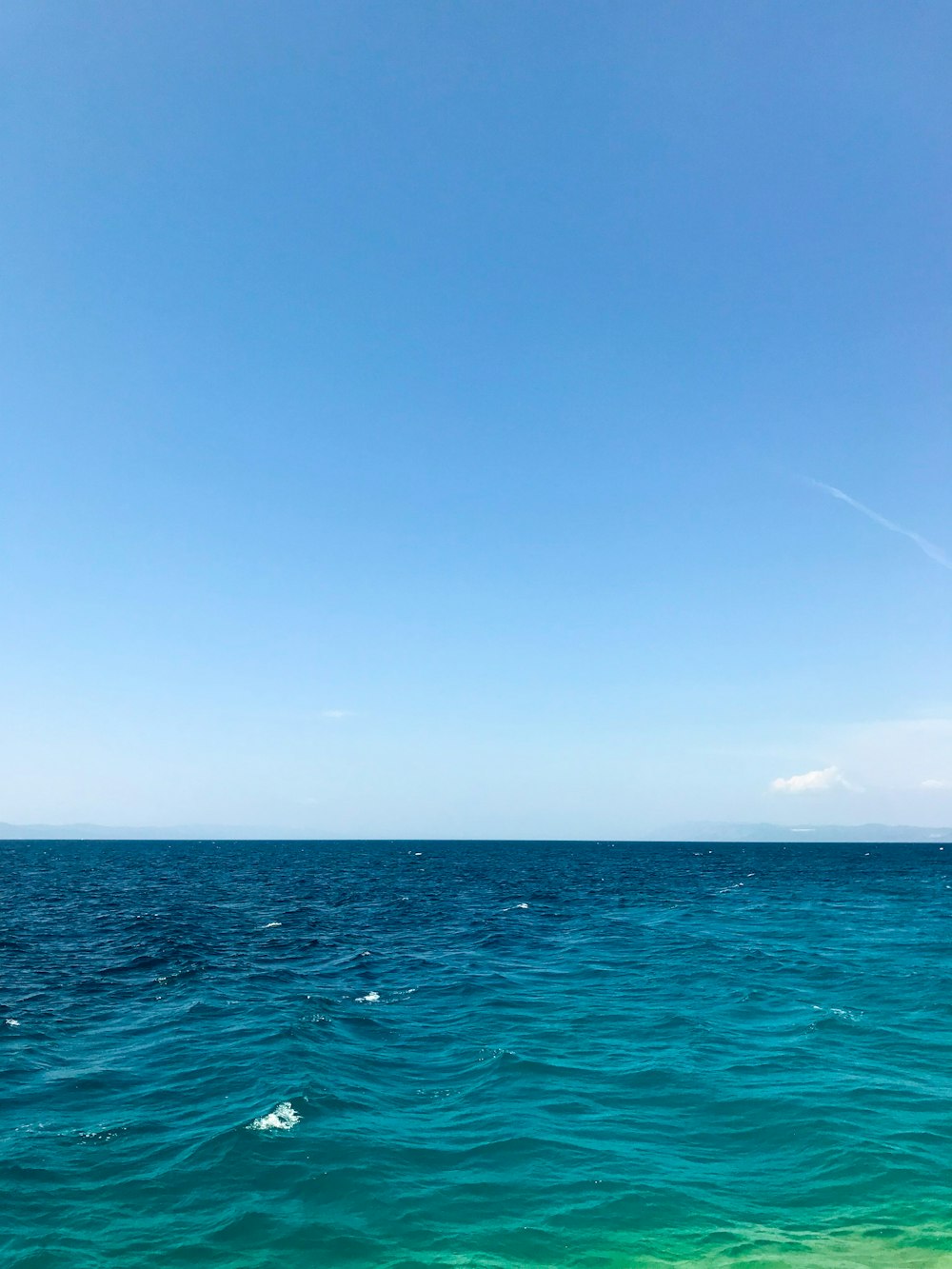 blue ocean under blue sky during daytime