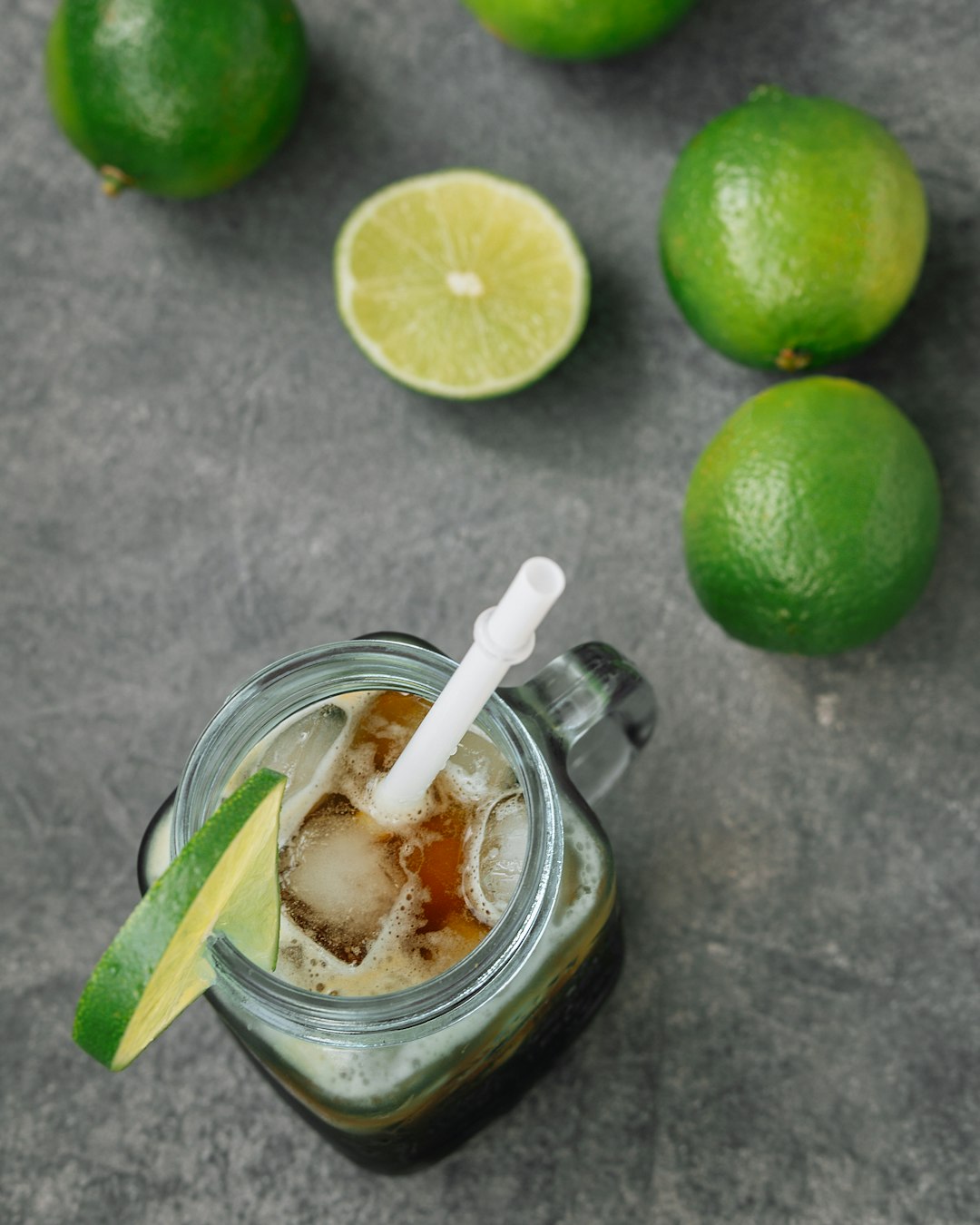 clear drinking glass with ice and sliced lemon