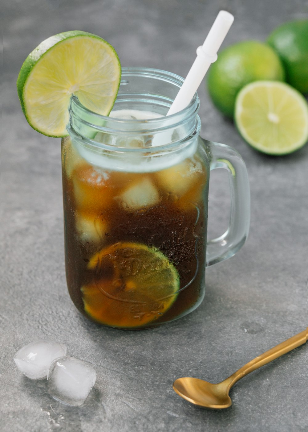 clear glass mug with brown liquid and ice