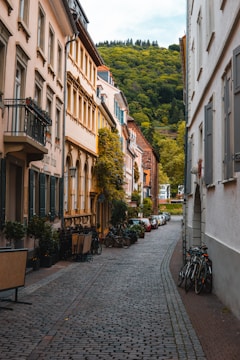 black bicycle parked on sidewalk in between of buildings during daytime