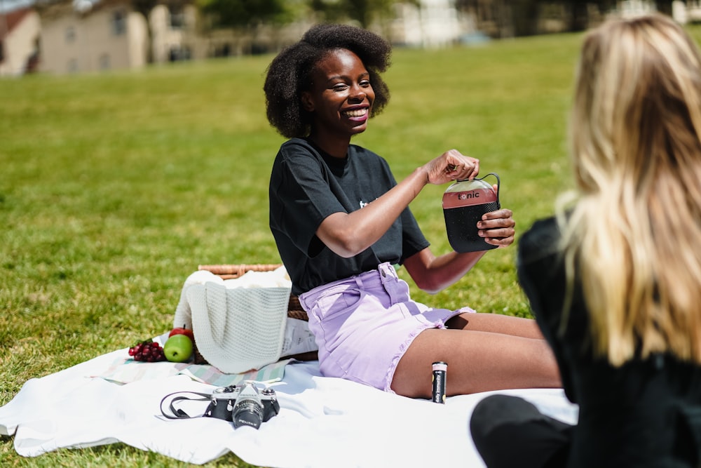 woman in black shirt and white shorts sitting on white table