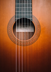 Close-up of a handcrafted classical guitar's rosette and soundhole.