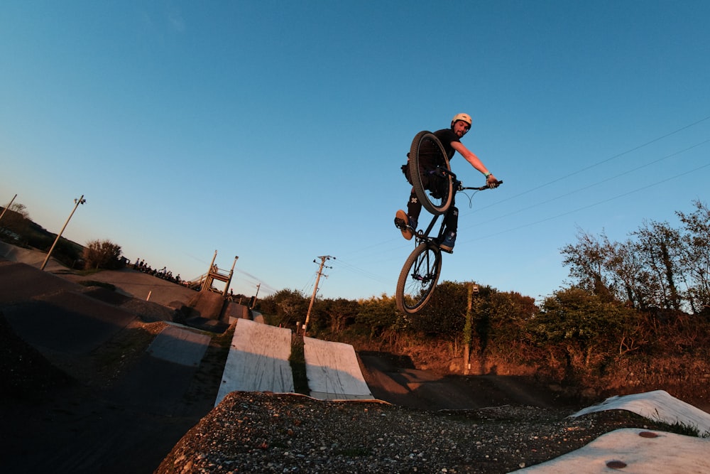 man in black jacket riding on bicycle during daytime