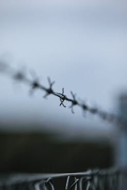 barbed wire fence at immigration detention and ICE custody