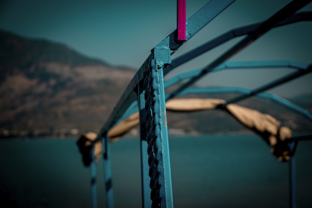 blue metal railings near body of water during daytime