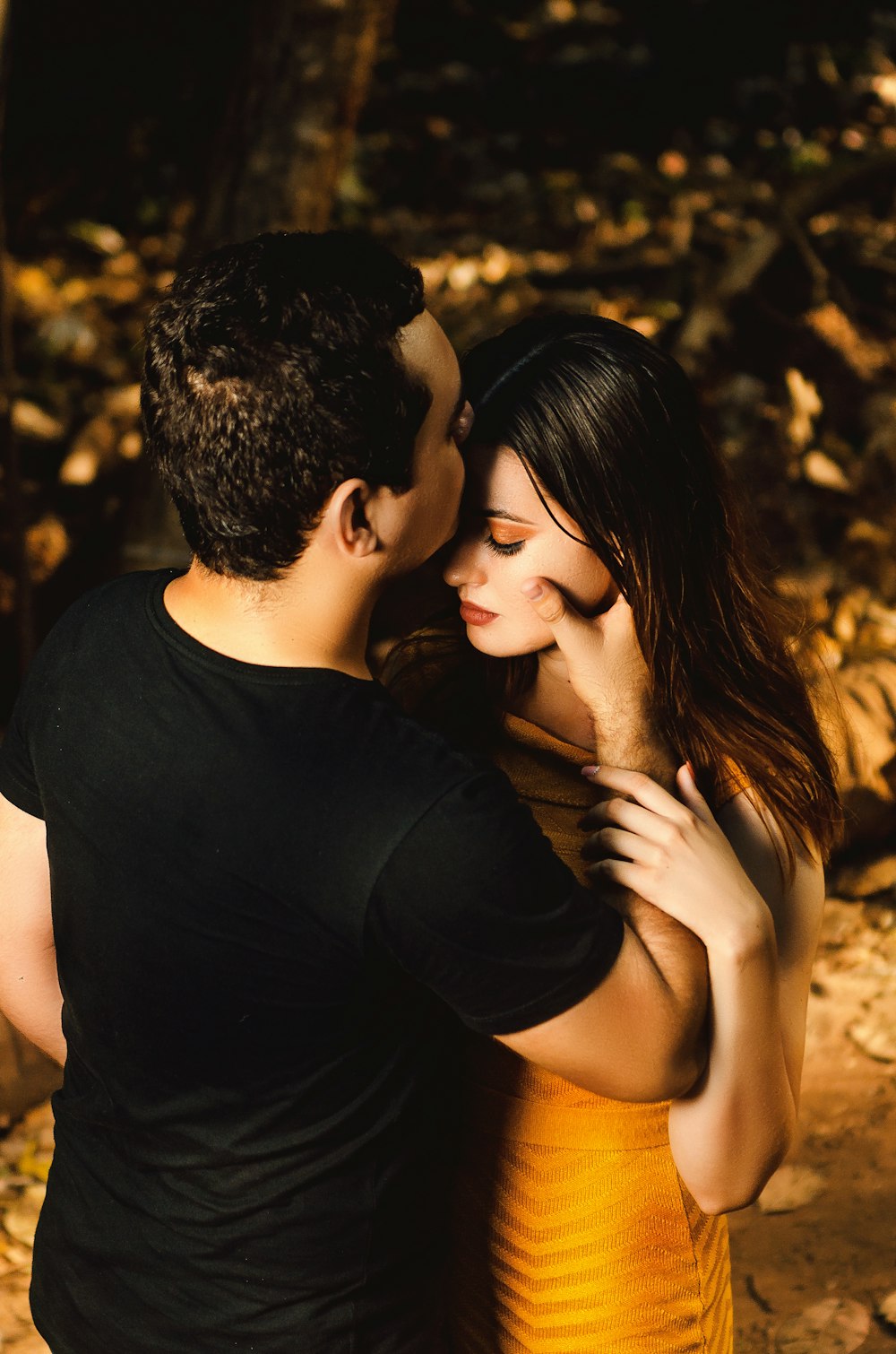 man and woman kissing during daytime