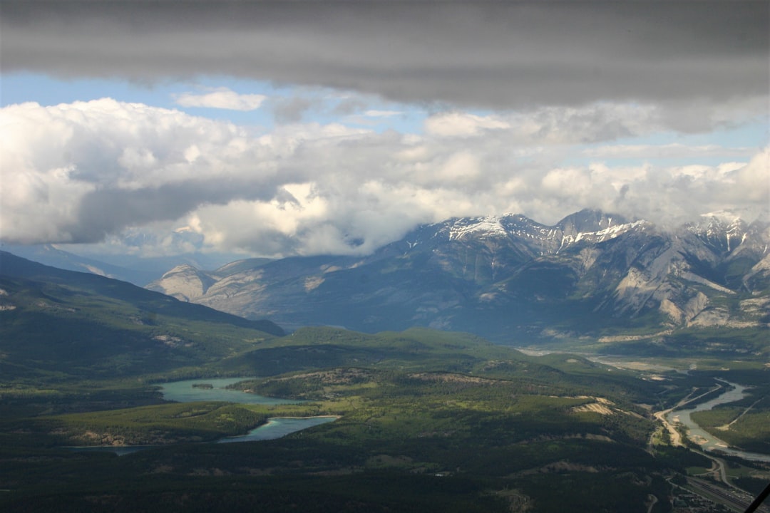 green and white mountains under white clouds during daytime