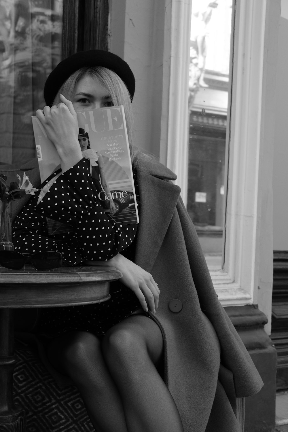 woman reading book sitting on chair