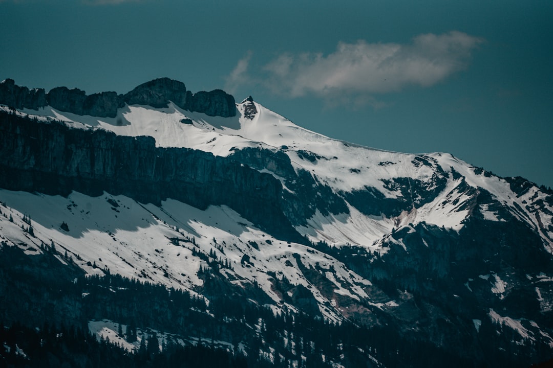 snow covered mountain under cloudy sky during daytime