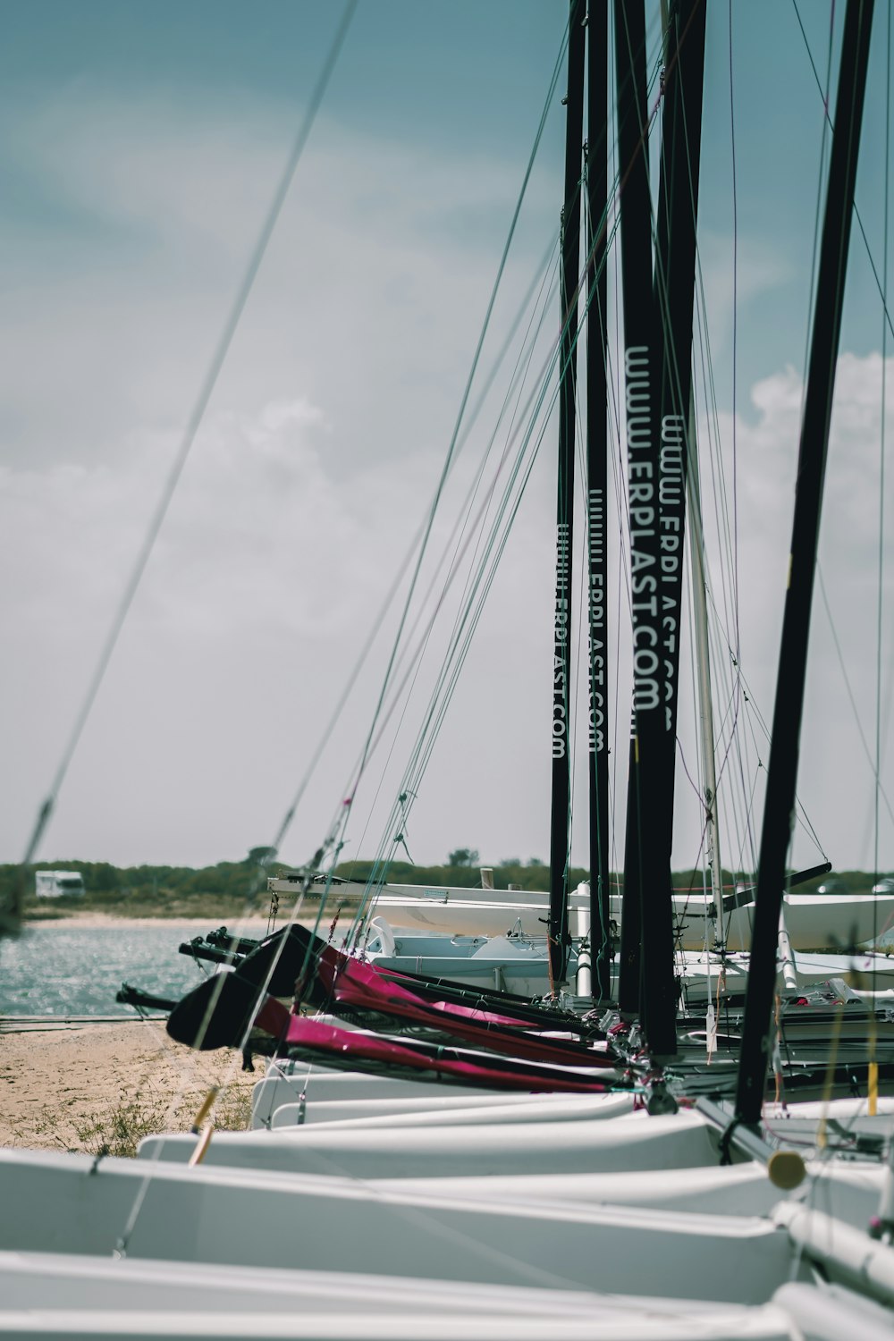 red and black boat on brown sand during daytime