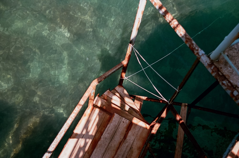 brown wooden ladder on body of water