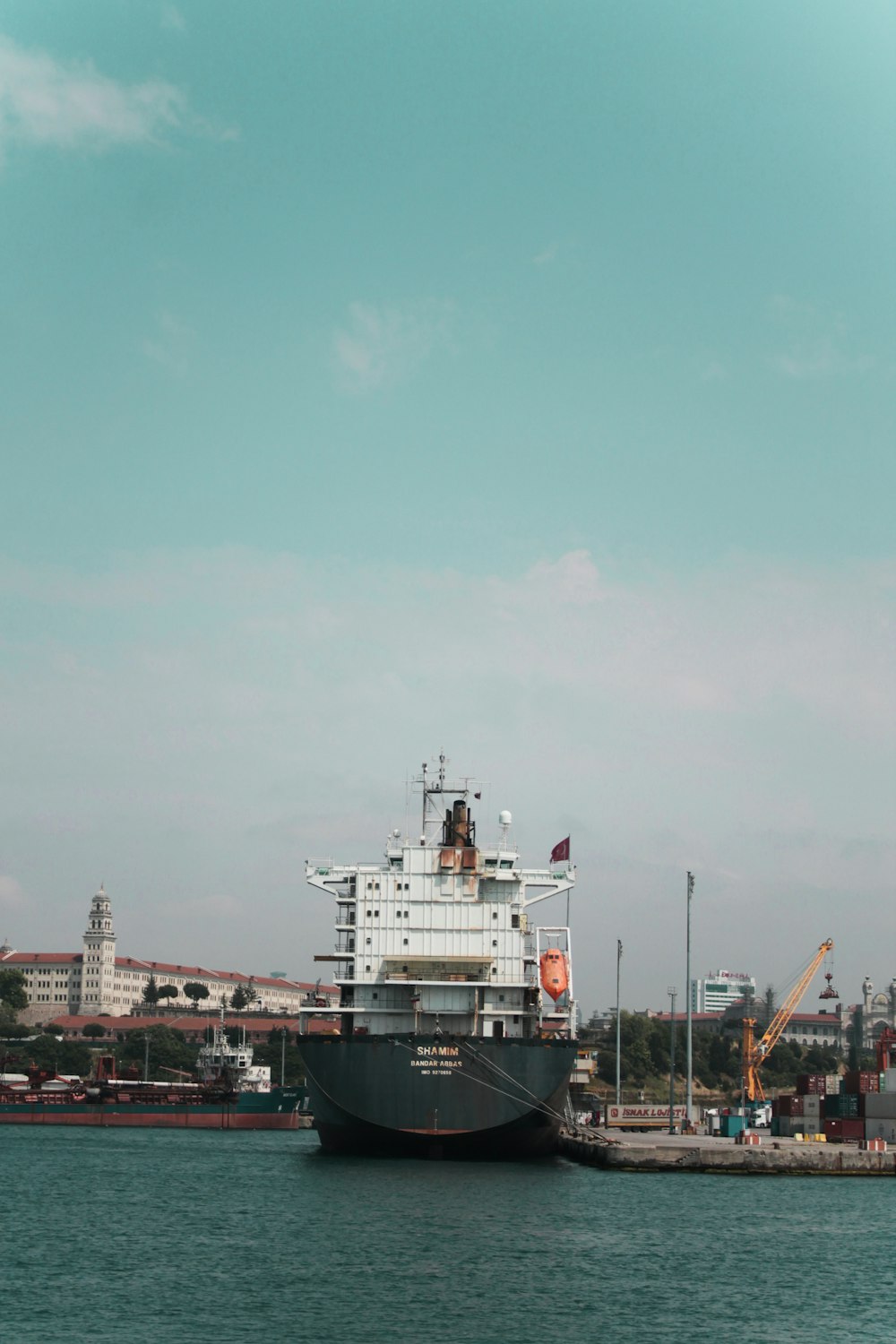 white and red ship on dock during daytime