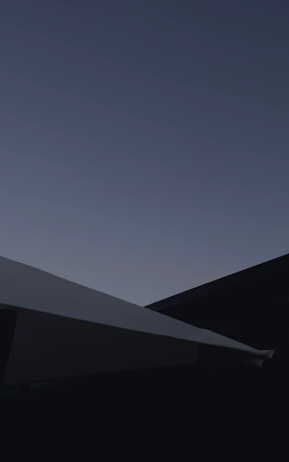 A minimalist urban landscape with sharp lines and soft shadows at dusk