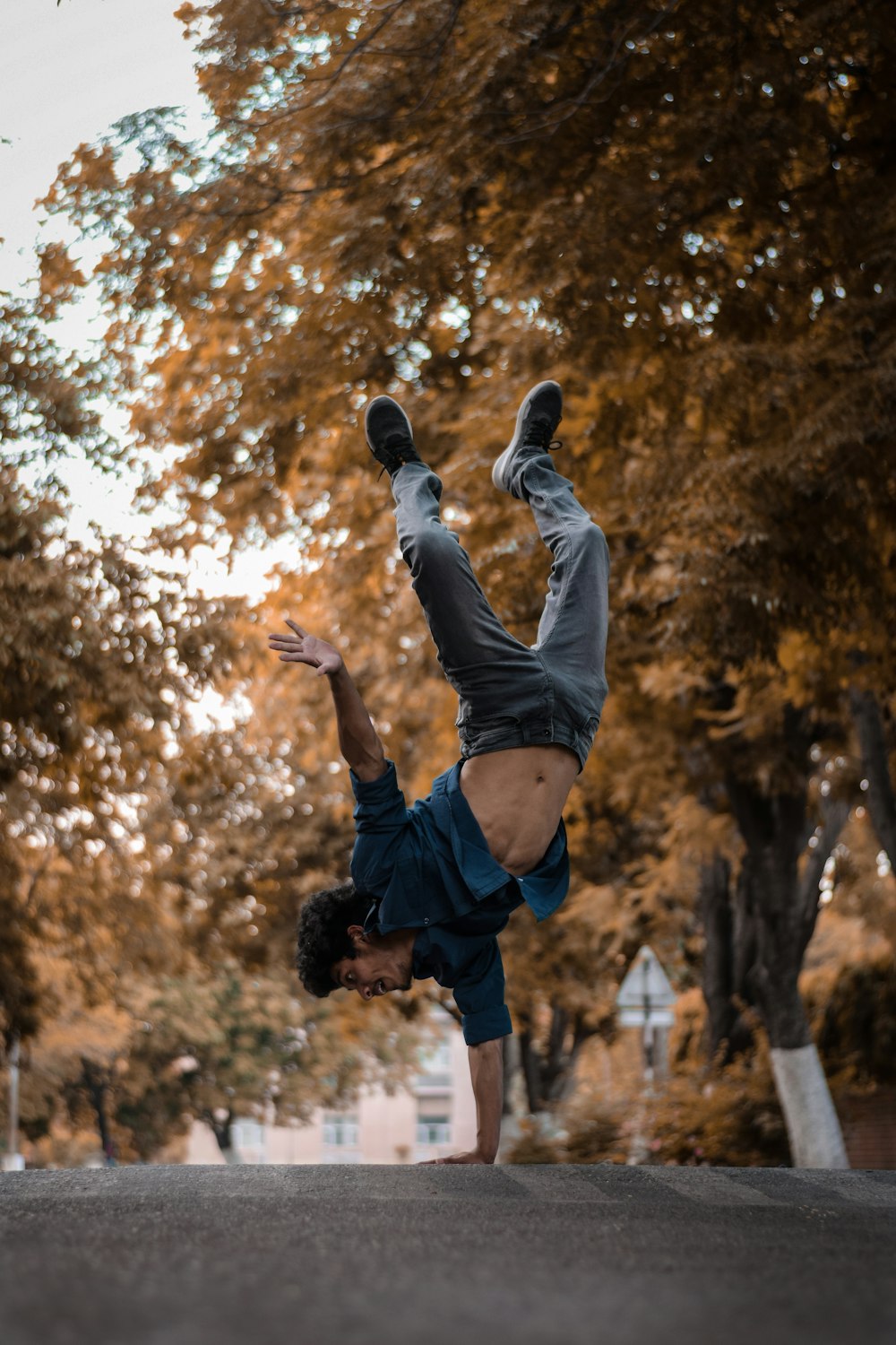 man in black shorts and white shirt jumping on air during daytime