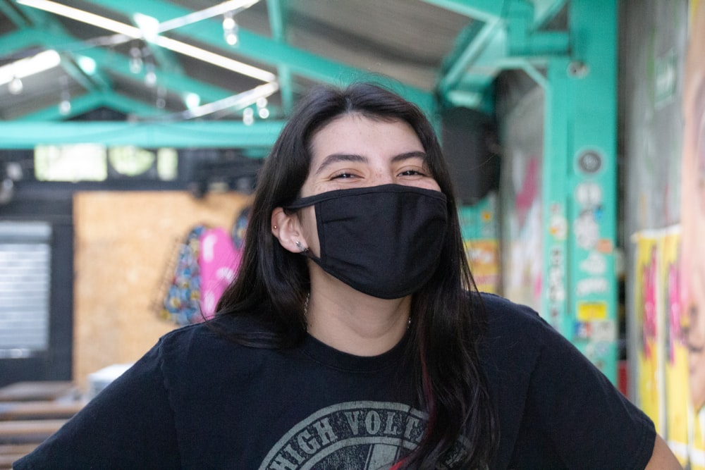 woman in black crew neck shirt wearing black mask