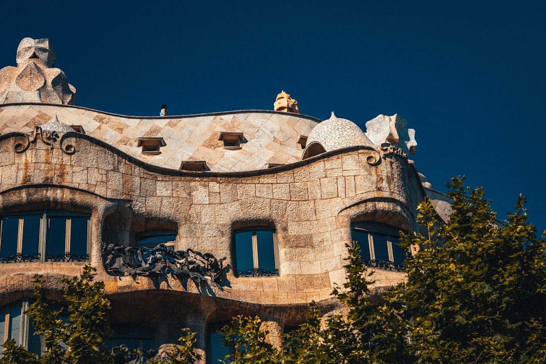 brown concrete building near green trees during daytime