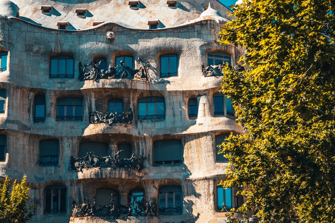 brown concrete building near green trees during daytime