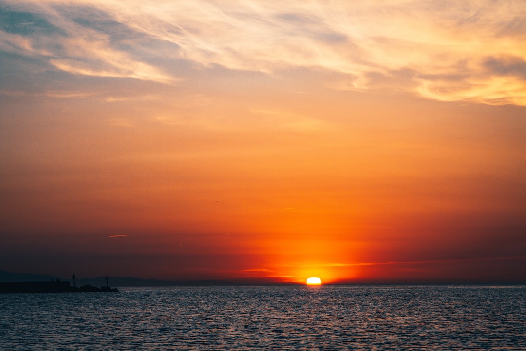 body of water during sunset