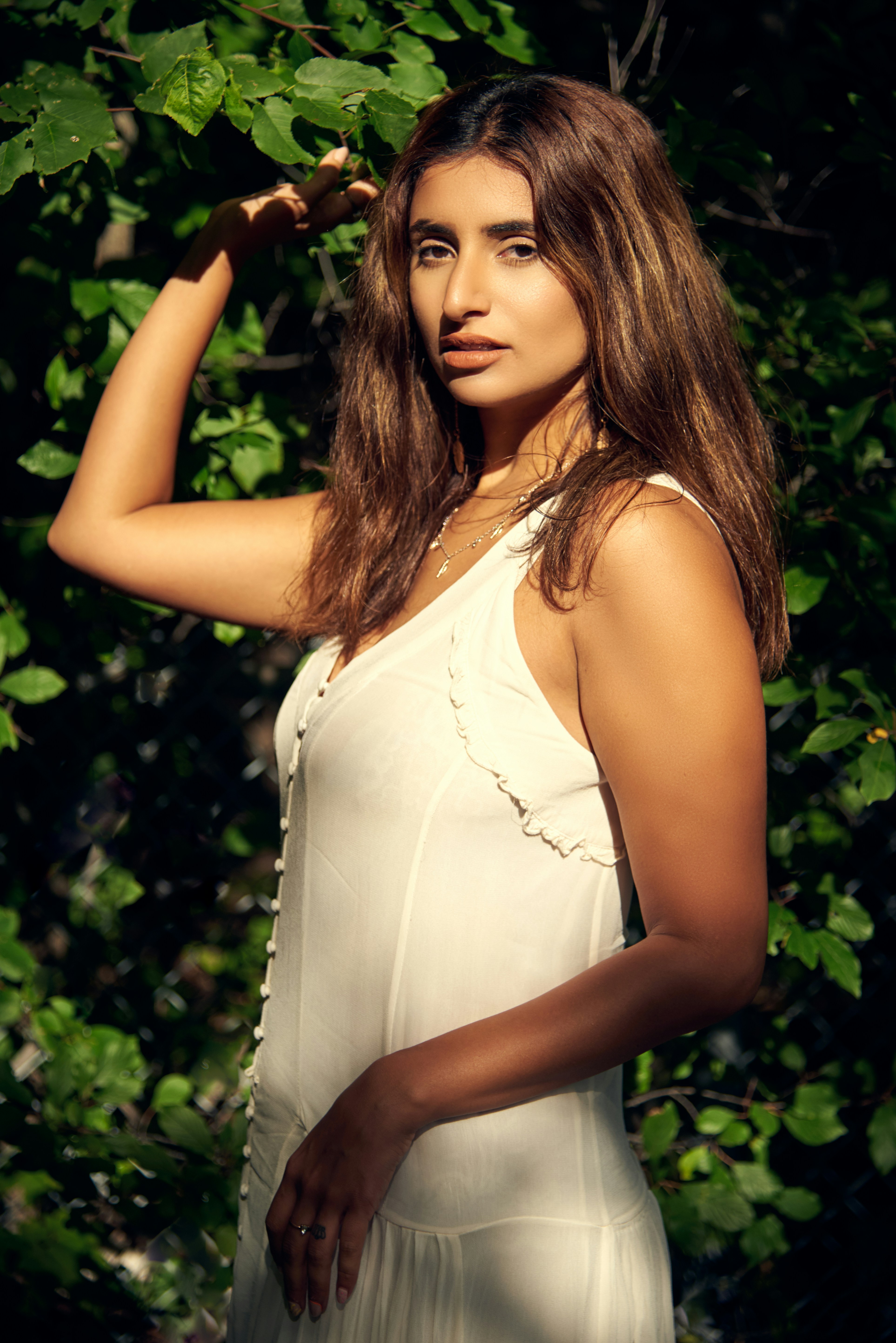Woman in white tank top standing near green plant photo – Free Nature ...