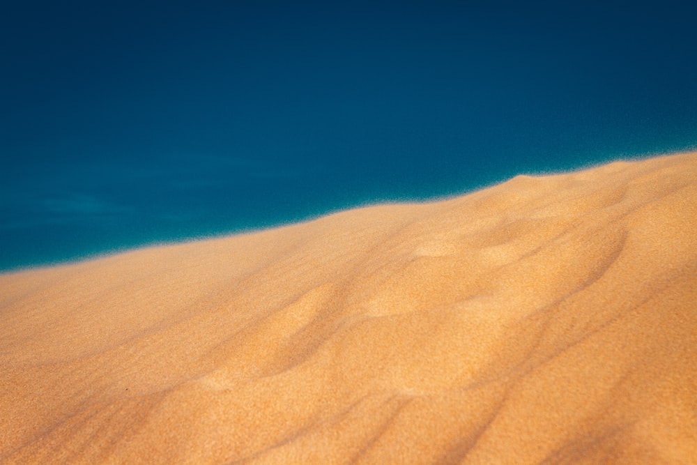 brown sand under blue sky during daytime