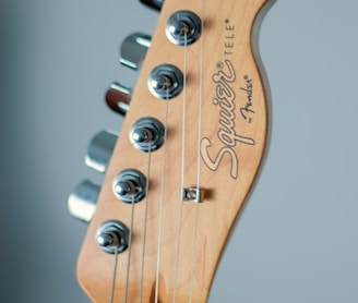 brown and white guitar headstock