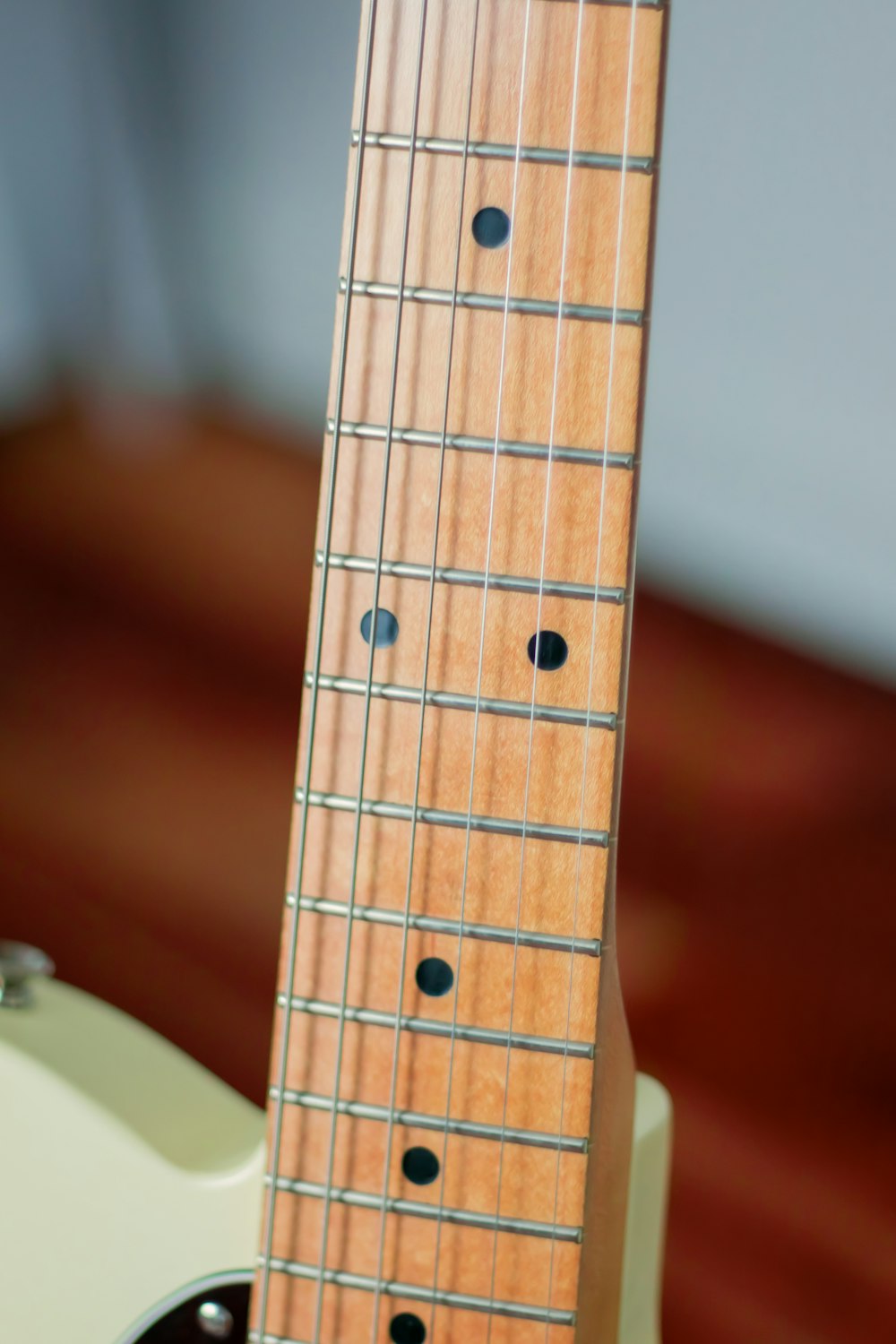 brown wooden acoustic guitar on brown wooden table