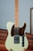 white and brown stratocaster electric guitar