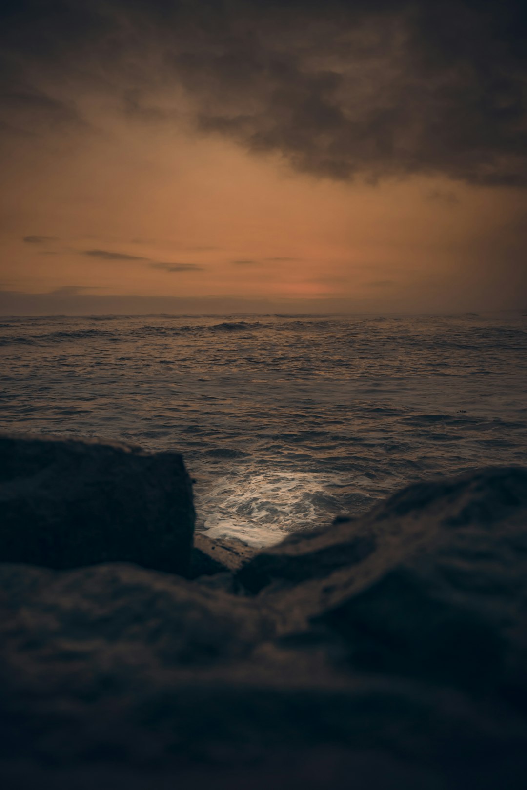 ocean waves crashing on rocks during sunset