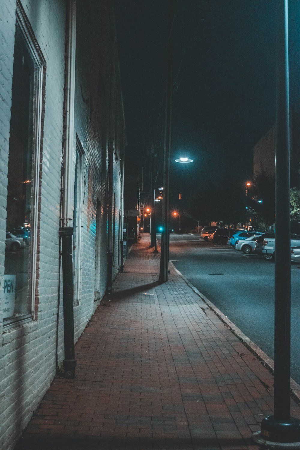 cars parked on sidewalk during night time